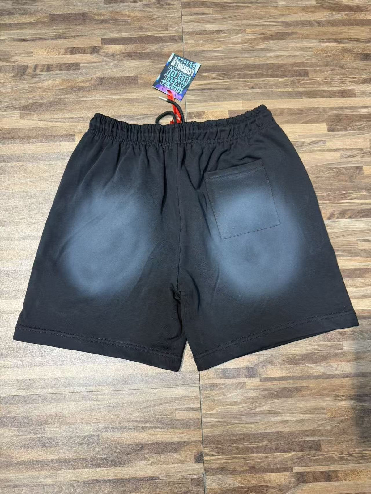 THAT'S A AWFUL LOT OF COUGH SYRUP Black Front Graphic Shorts — back